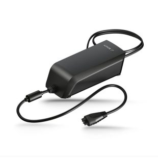 Black electric motorcycle battery charger with connection wires at both ends, white background.