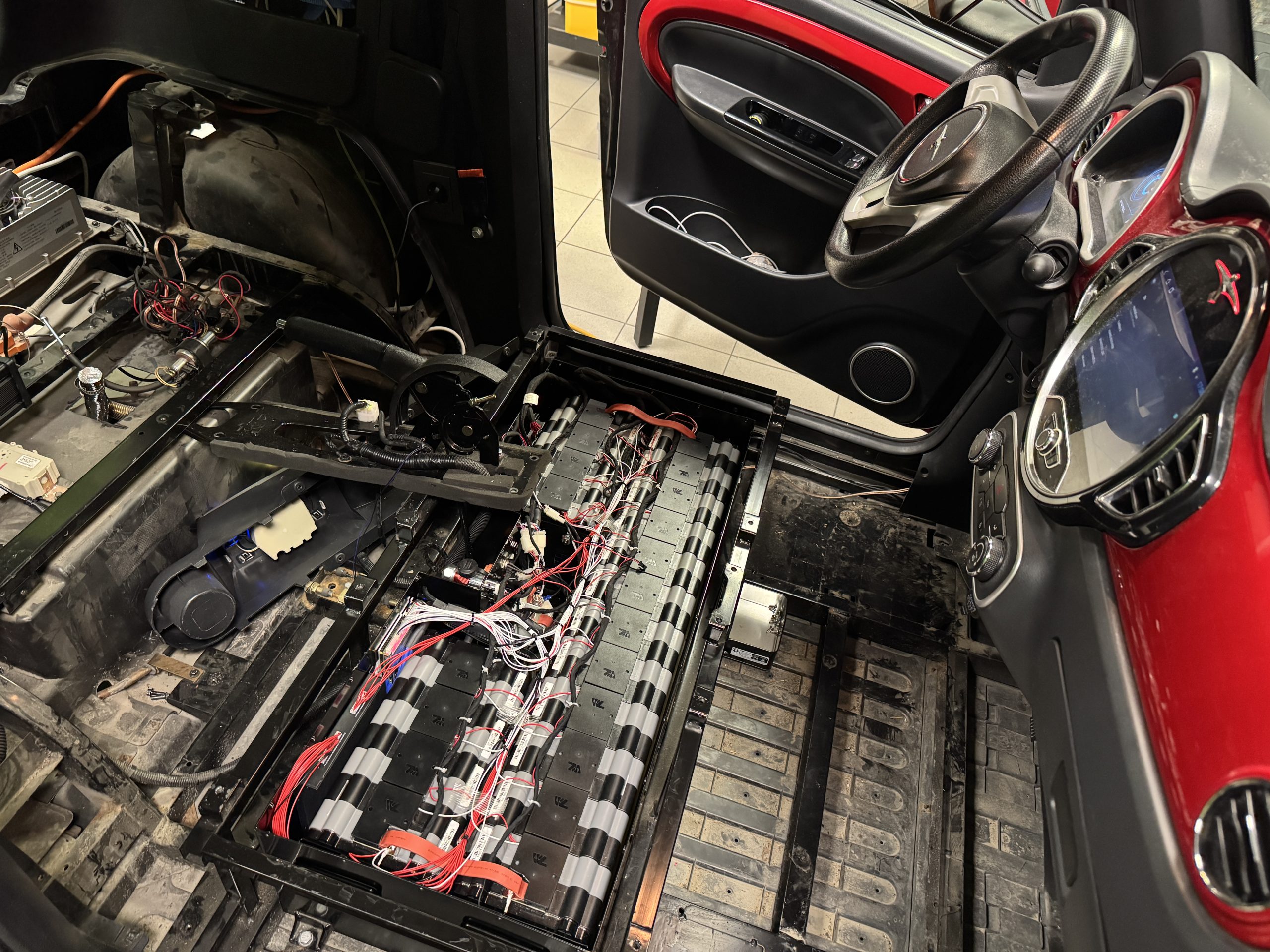 EV battery modules stripped down and cells checked during traction pack repair